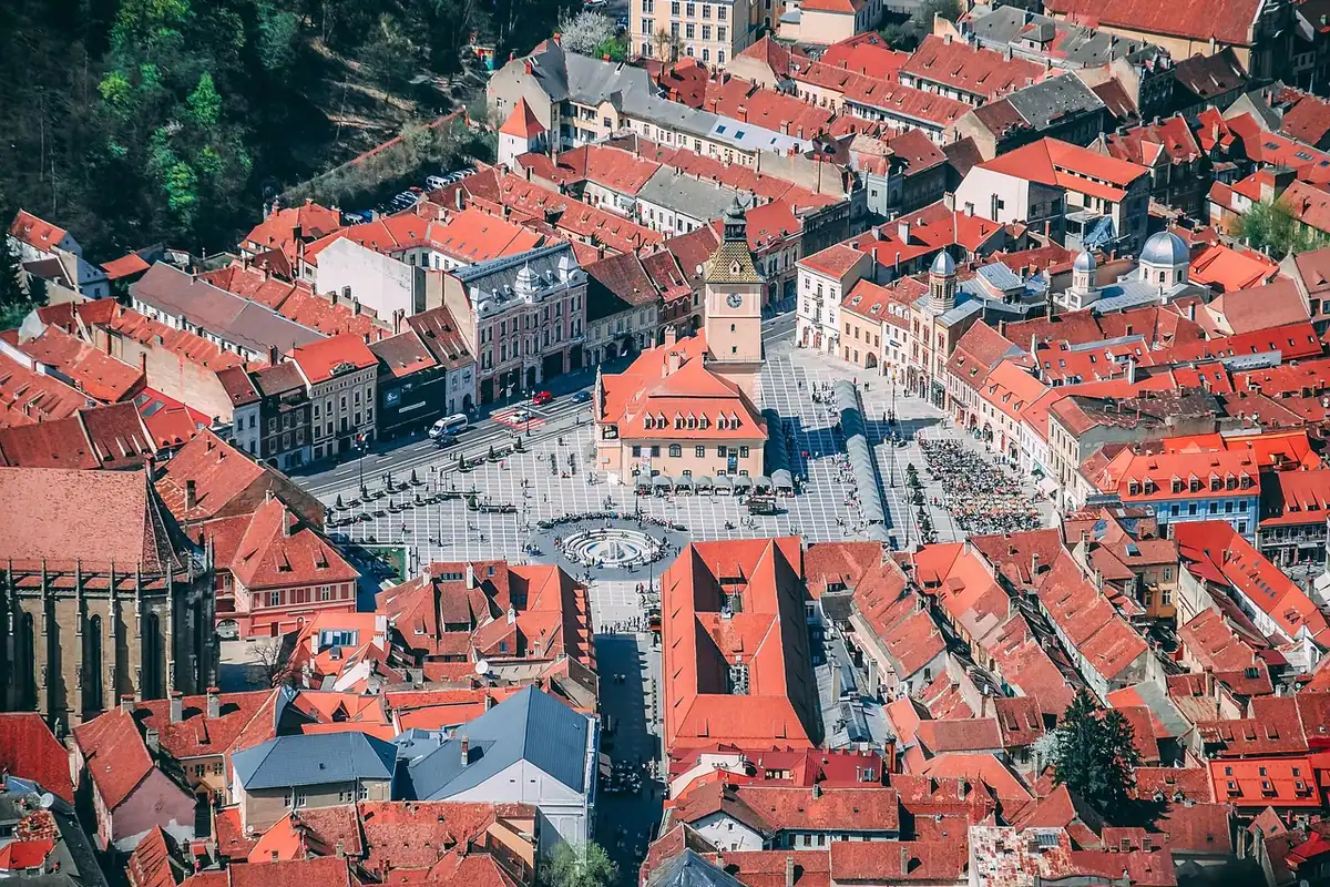 Piața Sfatului din Brașov văzută de sus, cu acoperișuri roșii și clădiri medievale